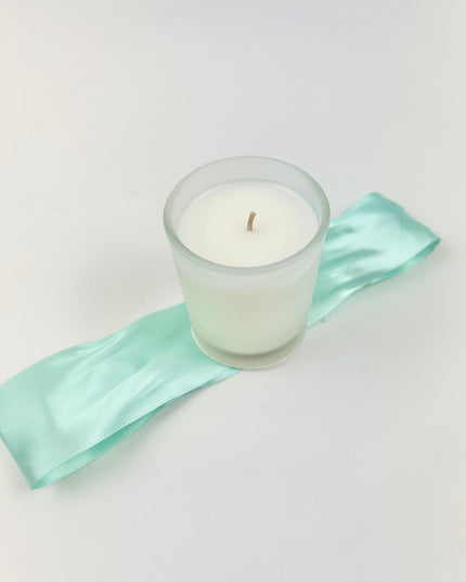 B's Knees Votive in Ocean Air Candles in  at Wrapsody