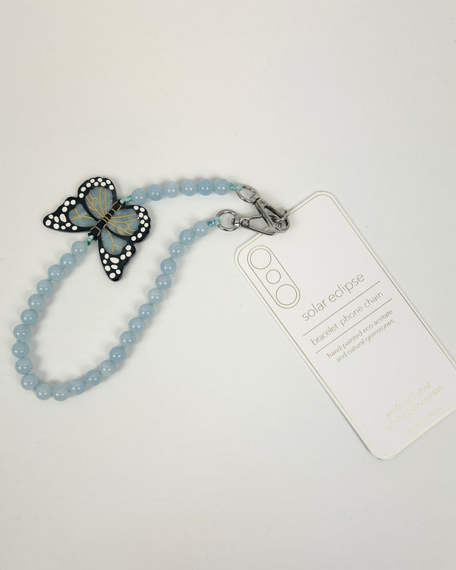 Solar Eclipse Monarch Butterfly Phone Chain Bracelet Travel Accessories in at Wrapsody